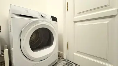 a white washing machine in a kitchen next to a door at Night next to the Museum in Prague