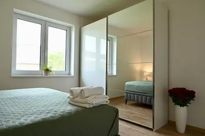 a white bunk bed in a room with a chair at Pool & Relax Mukařov in Srbín