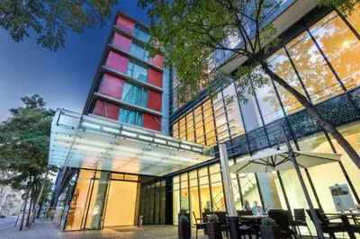 a building with tables and chairs in front of it at OREA Hotel Andels Depandance in Prague