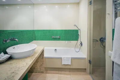 a bathroom with a tub and a sink and a shower at OREA Hotel Andels Depandance in Prague