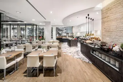 a restaurant with tables and chairs and a bakery at OREA Hotel Andels Depandance in Prague
