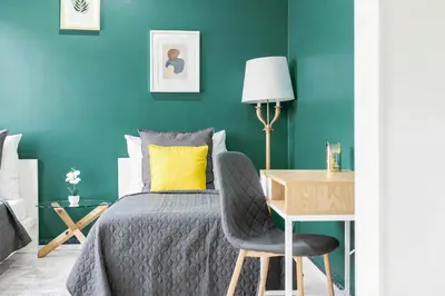 a bedroom with a bed and a desk with a chair at Cozy Central Two-Bedroom Apartment in Prague
