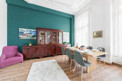a dining room with a table and a purple chair at Cozy Central Two-Bedroom Apartment in Prague