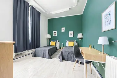 a bedroom with a bed and a desk in a room at Cozy Central Two-Bedroom Apartment in Prague