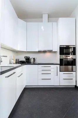 a white kitchen with white cabinets and appliances at Hound Deluxe Suite in Prague
