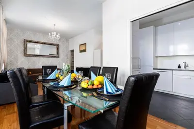 a dining room with a table with a bowl of fruit on it at Hound Deluxe Suite in Prague