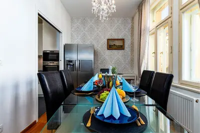 a dining room with a glass table with fruit on it at Hound Deluxe Suite in Prague