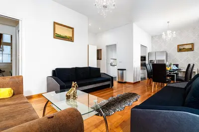 a living room with two couches and a table at Hound Deluxe Suite in Prague