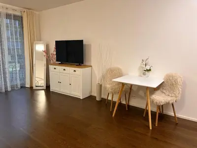 a living room with a table and two chairs and a television at Evas Cozy Studio Prague in Prague