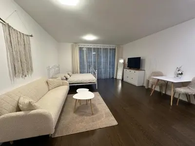 a living room with a couch and a table at Evas Cozy Studio Prague in Prague