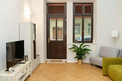 a living room with a tv and a door at Prague City Center 99m2 Andel Family Apartment for 6 Bath and Shower Self Check in in Prague
