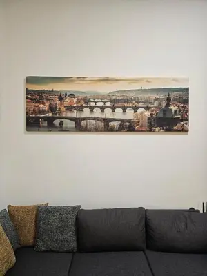 a picture hanging on a white wall above a couch at Bohemian Loft Apartament in Prague
