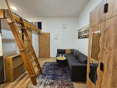 a living room with a couch and a bunk bed at Bohemian Loft Apartament in Prague