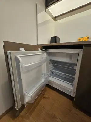 an empty refrigerator with its door open in a kitchen at Bohemian Loft Apartament in Prague