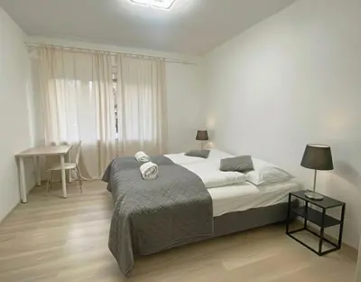 a bedroom with a bed and a desk in it at Spacious 3BR Apartment near Metro in Prague