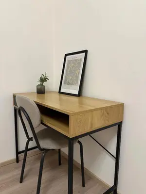 a wooden desk with a chair next to a wall at Spacious 3BR Apartment near Metro in Prague