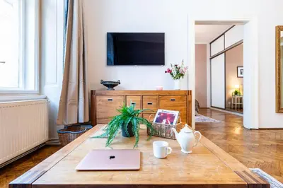 a living room with a coffee table and a tv at Prague Days - Two Bedroom Apartment next to Dancing House with High-Speed WiFi in Prague
