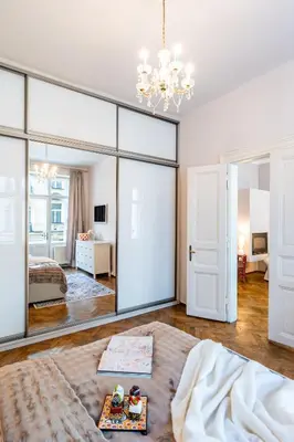 a bedroom with a large mirror and a bed at Prague Days - Two Bedroom Apartment next to Dancing House with High-Speed WiFi in Prague