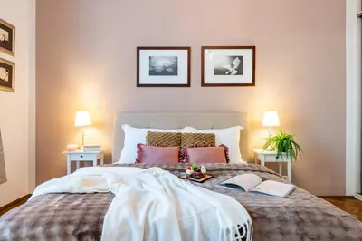 a bedroom with a large bed with two lamps at Prague Days - Two Bedroom Apartment next to Dancing House with High-Speed WiFi in Prague