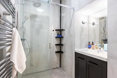 a bathroom with a shower and a sink at Prague Days - Two Bedroom Apartment next to Dancing House with High-Speed WiFi in Prague
