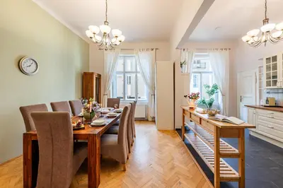 a kitchen and dining room with a table and chairs at Prague Days - Two Bedroom Apartment next to Dancing House with High-Speed WiFi in Prague