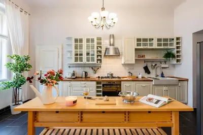 a kitchen with a wooden table with flowers on it at Prague Days - Two Bedroom Apartment next to Dancing House with High-Speed WiFi in Prague