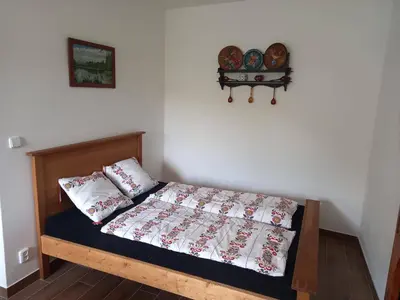 a bedroom with a bed with two pillows on it at Ubytováni U rybníčku in Bzová