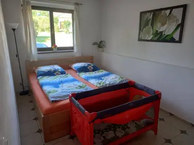 a small bedroom with a bed and a window at Ubytováni U rybníčku in Bzová
