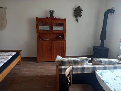 a room with a bed and a cabinet and a couch at Ubytováni U rybníčku in Bzová