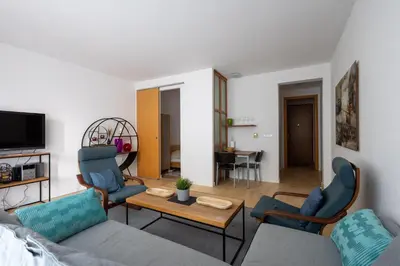 a small kitchen with white cabinets and a sink at Cosy Parkside Apartment Prague in Prague