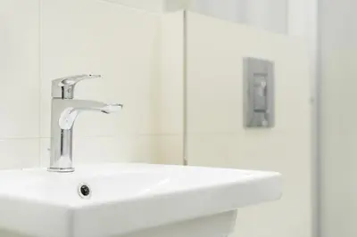 a white sink in a bathroom with a mirror at Rentero Central Apartment near Charles Square in Prague