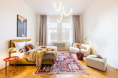a bedroom with a bed and a rug at Prague Days - Four Bedroom Apartment with Workspace and 250Mbs WiFi in New Town in Prague