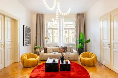 a living room with a couch and a red rug at Prague Days - Four Bedroom Apartment with Workspace and 250Mbs WiFi in New Town in Prague