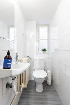 a white bathroom with a toilet and a sink at Prague Days - Four Bedroom Apartment with Workspace and 250Mbs WiFi in New Town in Prague