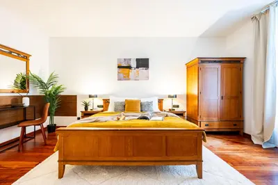 a bedroom with a large bed and a desk at Prague Days - Three Bedroom Apartment with AC, Desk and 100Mbs WiFi in New Town in Prague