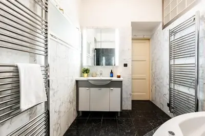 a bathroom with a sink and a mirror at Prague Days - Three Bedroom Apartment with AC, Desk and 100Mbs WiFi in New Town in Prague
