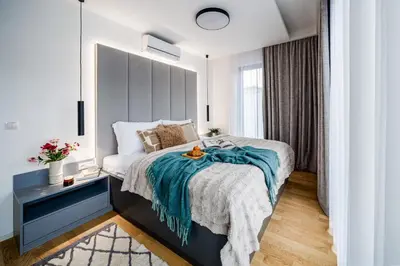 a bedroom with a bed with a blue blanket at Prague Days - Two Bedroom Apartment with Garage, AC, Terrace and Balcony in Vinohrady in Prague