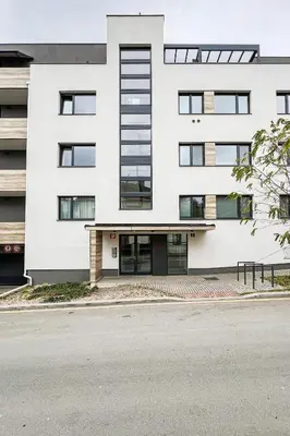a white building on the side of a street at Prague Days - Two Bedroom Apartment with Garage, AC, Terrace and Balcony in Vinohrady in Prague
