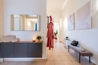 a living room with a dresser and a bench in a room at Prague Days - Riverside Two-Bedroom Apartment with Workspace in New Town in Prague