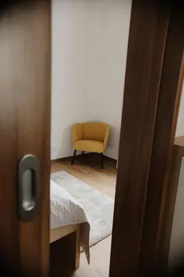 a hallway with a table and a room with white walls at Apartmány park in Poděbrady