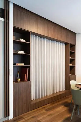 a living room with a window with white curtains at Boutique Apartment by KODA Architekt in Prague