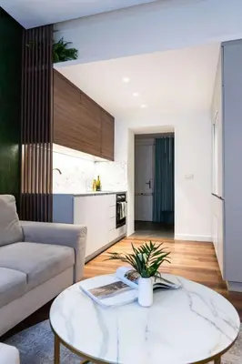 a living room with a couch and a table at Boutique Apartment by KODA Architekt in Prague