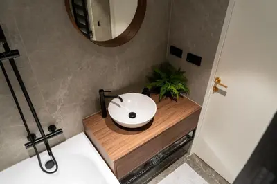 a bathroom with a white sink and a mirror at Boutique Apartment by KODA Architekt in Prague
