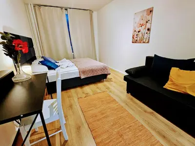 a small living room with a bed and a couch at SUPERIOR PRAGUE 2BR APARTMENT for Business & Leisure, Private Garden, Free Parking & Gym, by LIVE-INN 1 in Prague