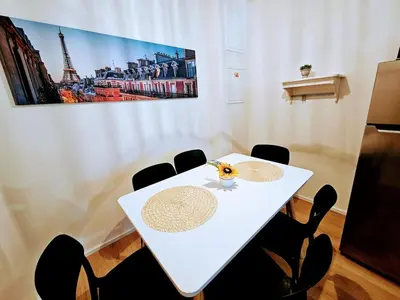a white table with chairs and a picture of the eiffel tower at SUPERIOR PRAGUE 2BR APARTMENT for Business & Leisure, Private Garden, Free Parking & Gym, by LIVE-INN 1 in Prague