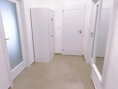a hallway with white doors and a tile floor at Central Apartment by National Museum&Wenceslas Square in Prague