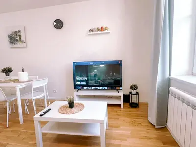 a living room with a tv and a table at Central Apartment by National Museum&Wenceslas Square in Prague