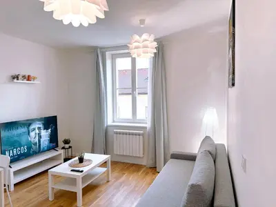 a living room with a couch and a tv at Central Apartment by National Museum&Wenceslas Square in Prague