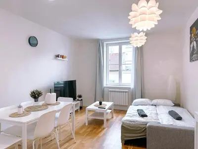 a living room with a bed and a dining room at Central Apartment by National Museum&Wenceslas Square in Prague