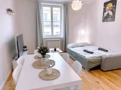 a living room with a dining table and a bed at Central Apartment by National Museum&Wenceslas Square in Prague